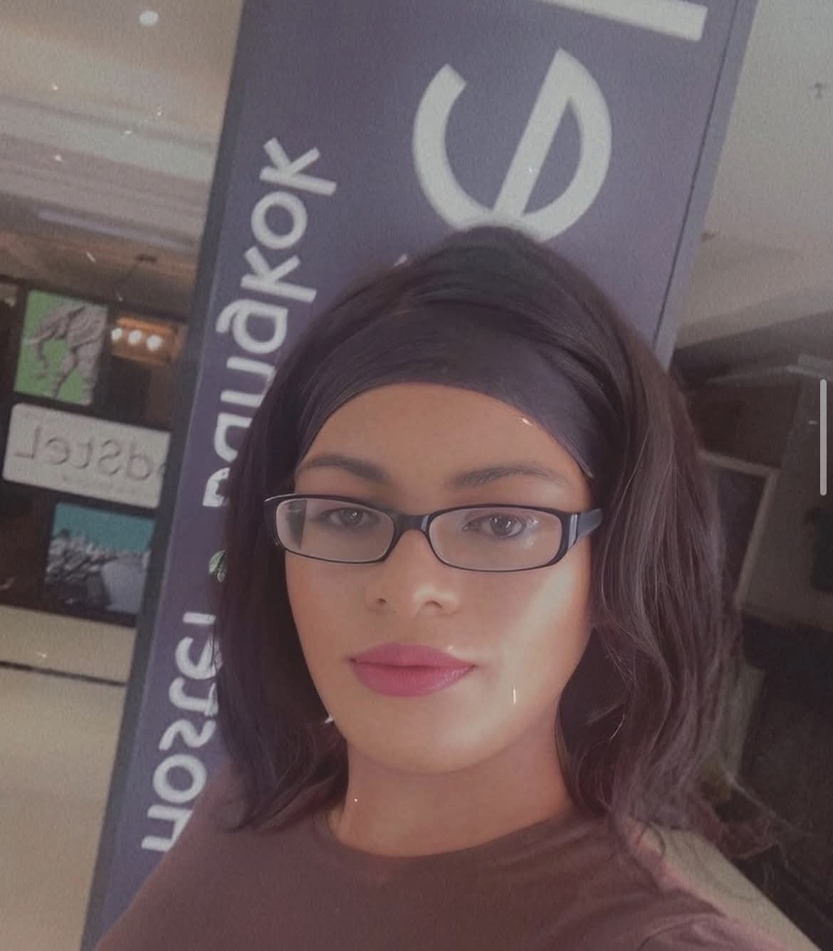 Selfie of me with a headband and glasses, standing indoors